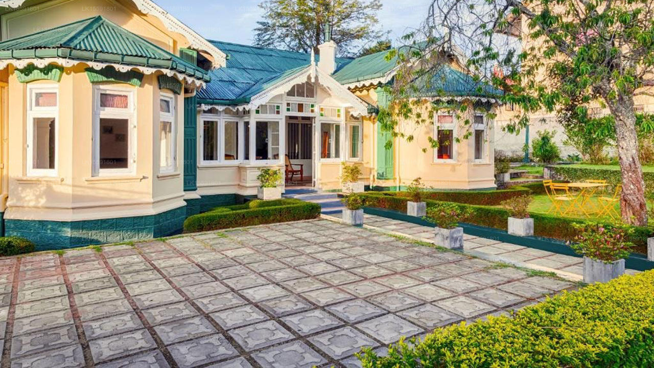 Victorian-style house with a well-maintained garden and patio.