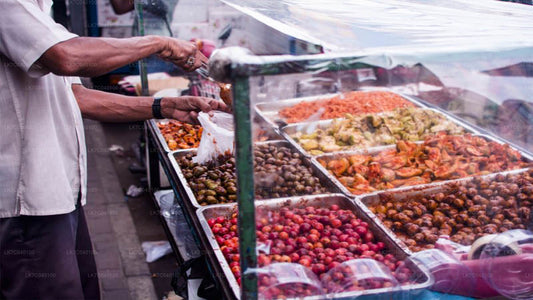 Vendor selling various types of street food at a market in Galle Fort, Sri Lanka.
